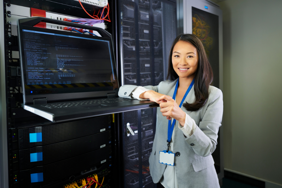 Confident woman leaning on a server laptop